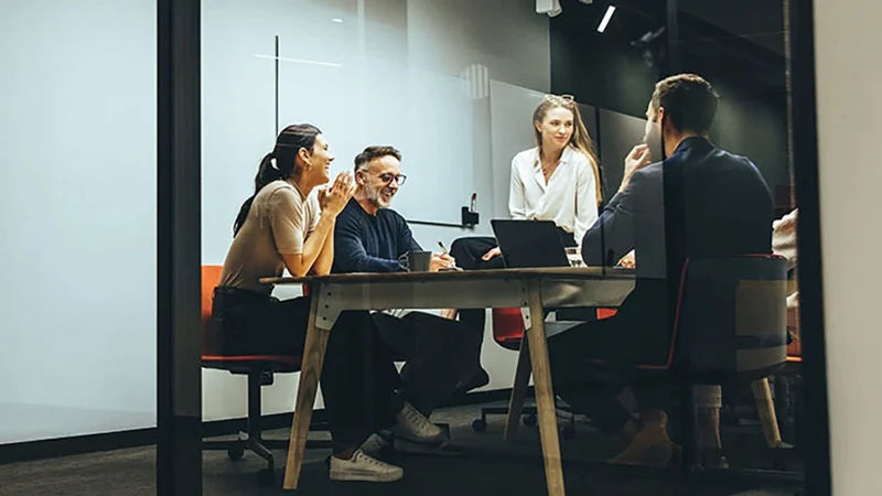 Business people in a conference room discuss the European Global Corporate Trust services at U.S. Bank. 