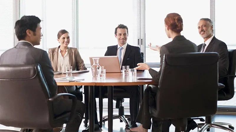Five Irish professionals around a table talking about investment funds 