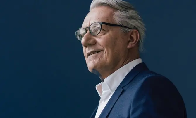 Older professional man wearing a suit and smiling