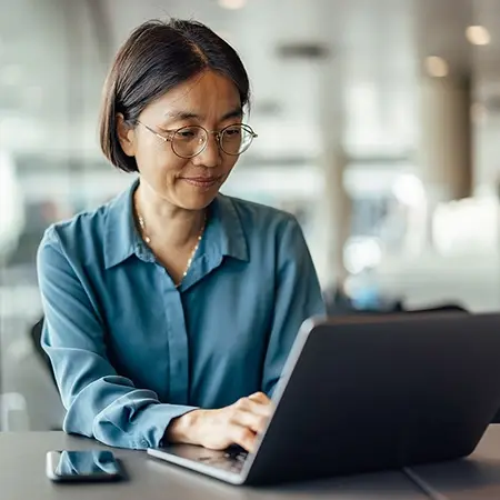 Woman searching for European fund administration solutions on her computer