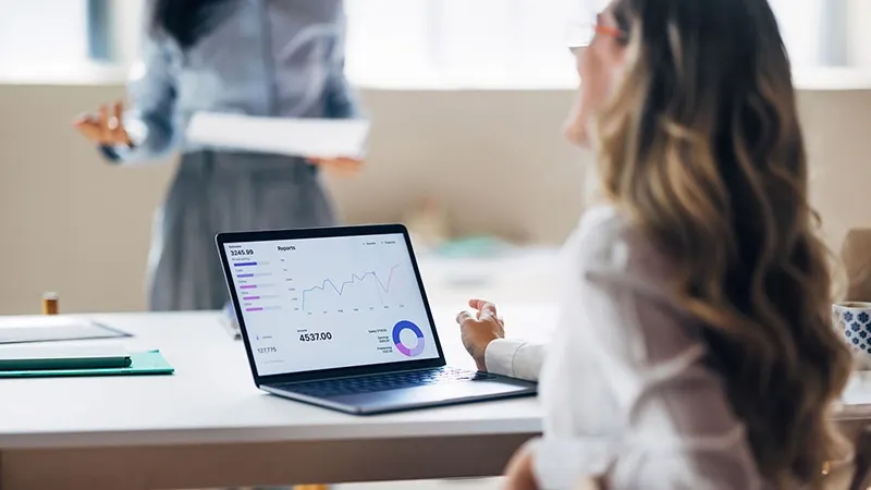 Woman using her laptop to research investment funds in Luxembourg 